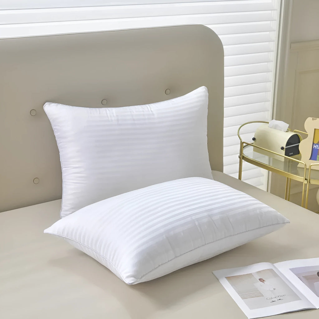 White cotton satin stripe pillow with feather filling in three size options for hotel or home use