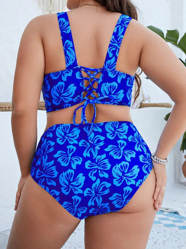Blue floral print women's plus-size split bikini swimsuit on a hanger.