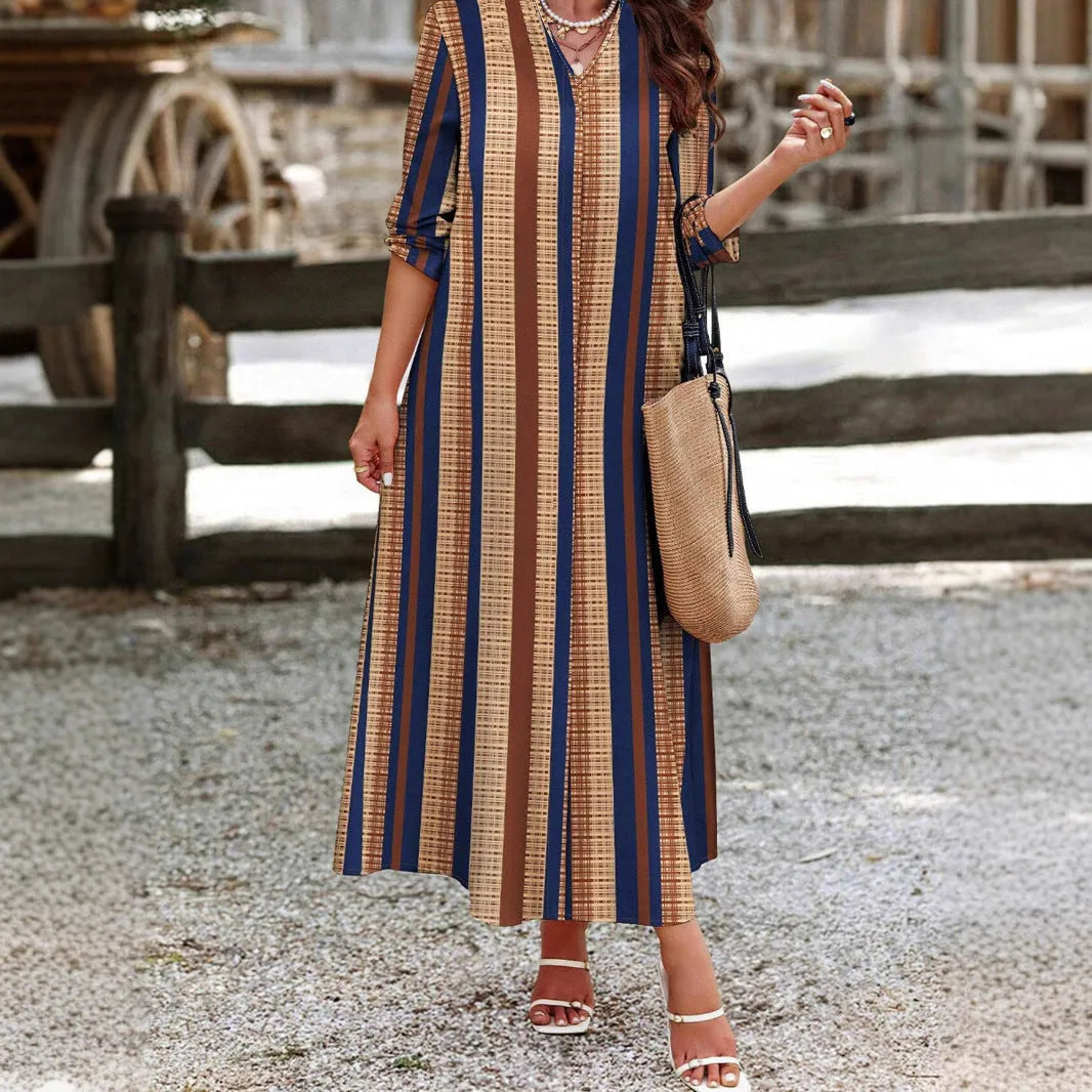 Camel coloured women's vertical striped V-neck long dress with long sleeves and an A-line skirt.