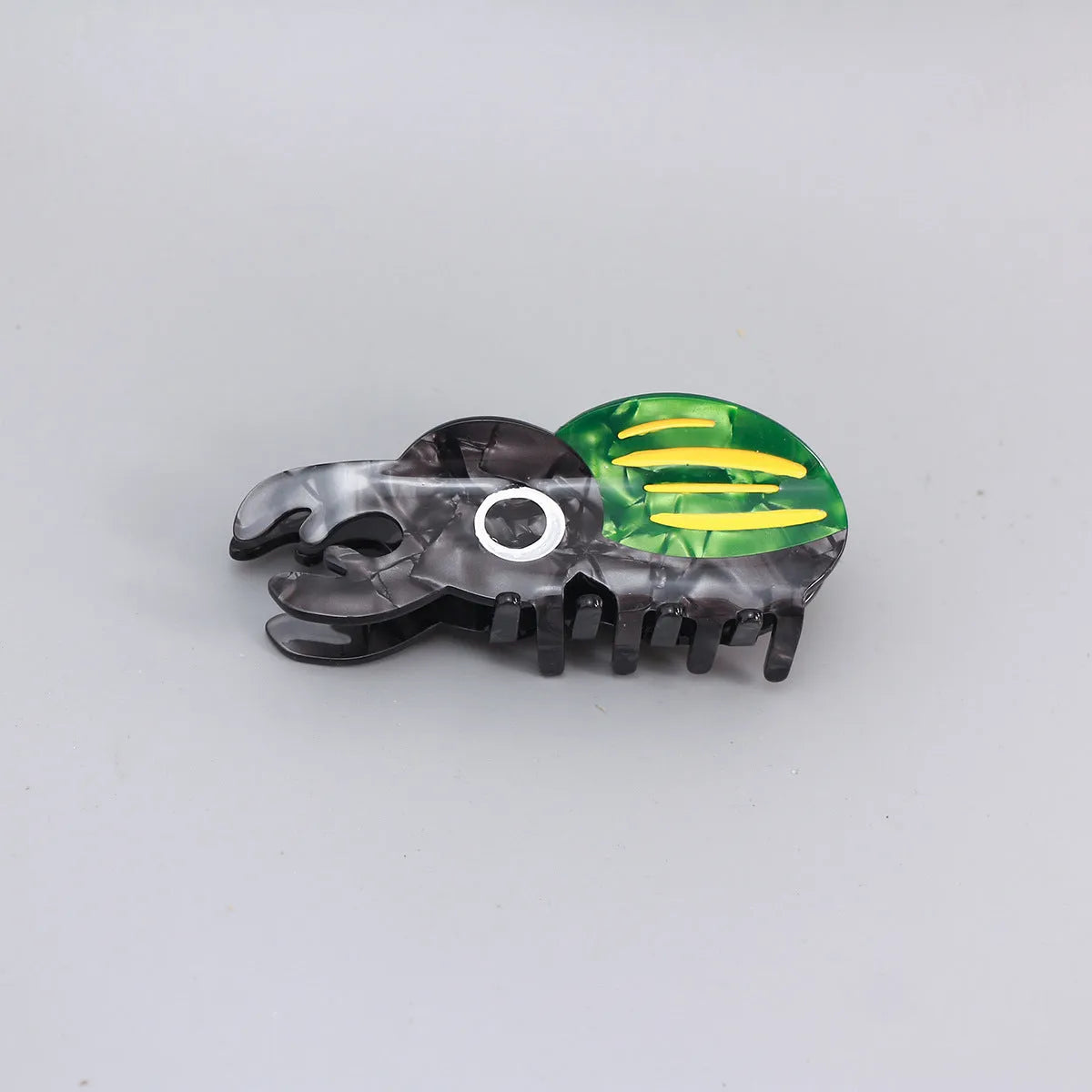 Handmade cellulose acetate beetle grip hair clip with cartoon caterpillar design in green, orange and white colours
