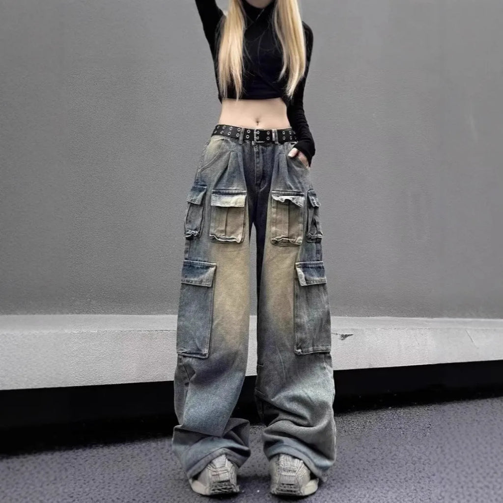 Man wearing loose fit light blue denim jeans with multiple tooling style pockets.