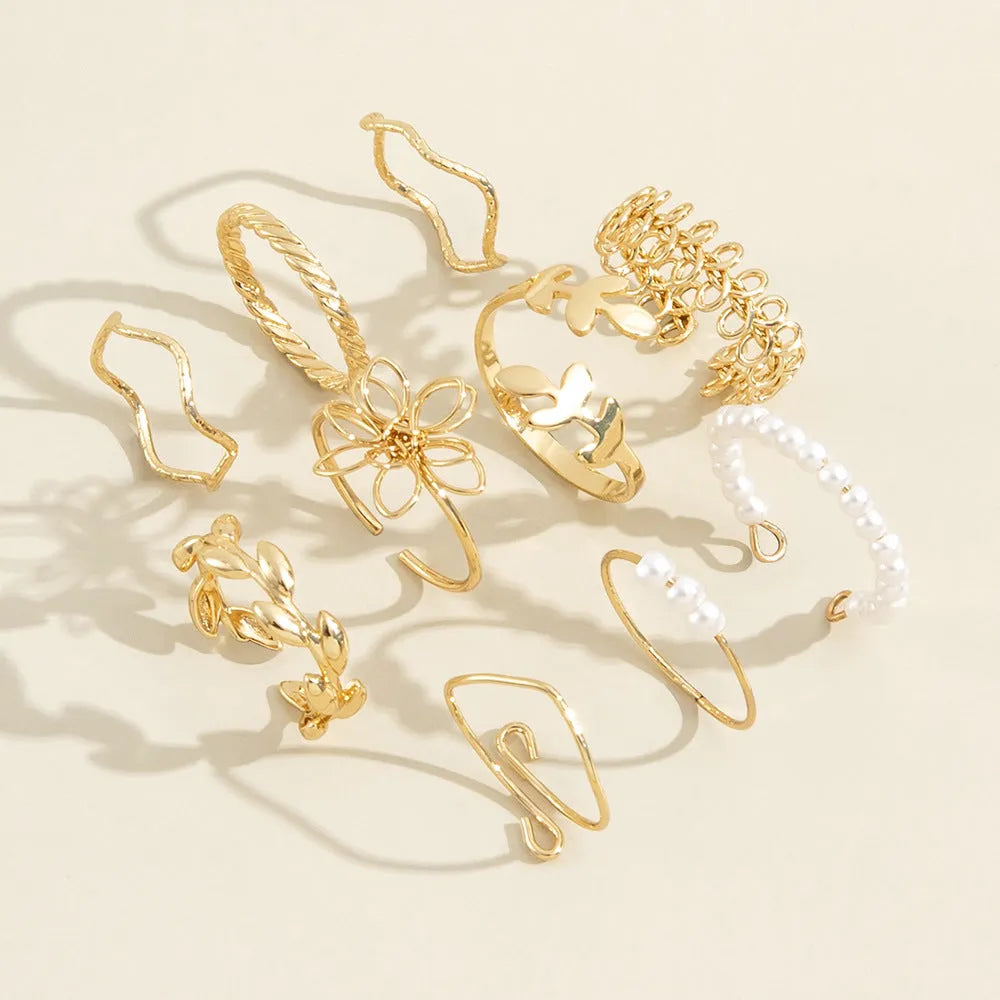 Gold-coloured alloy ring with openwork floral design and glossy electroplated finish