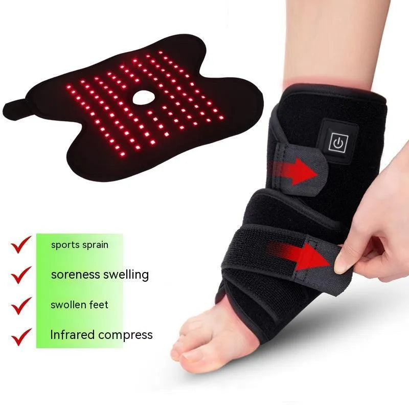 Black ankle heating wrap with red light therapy and USB cable on flat surface