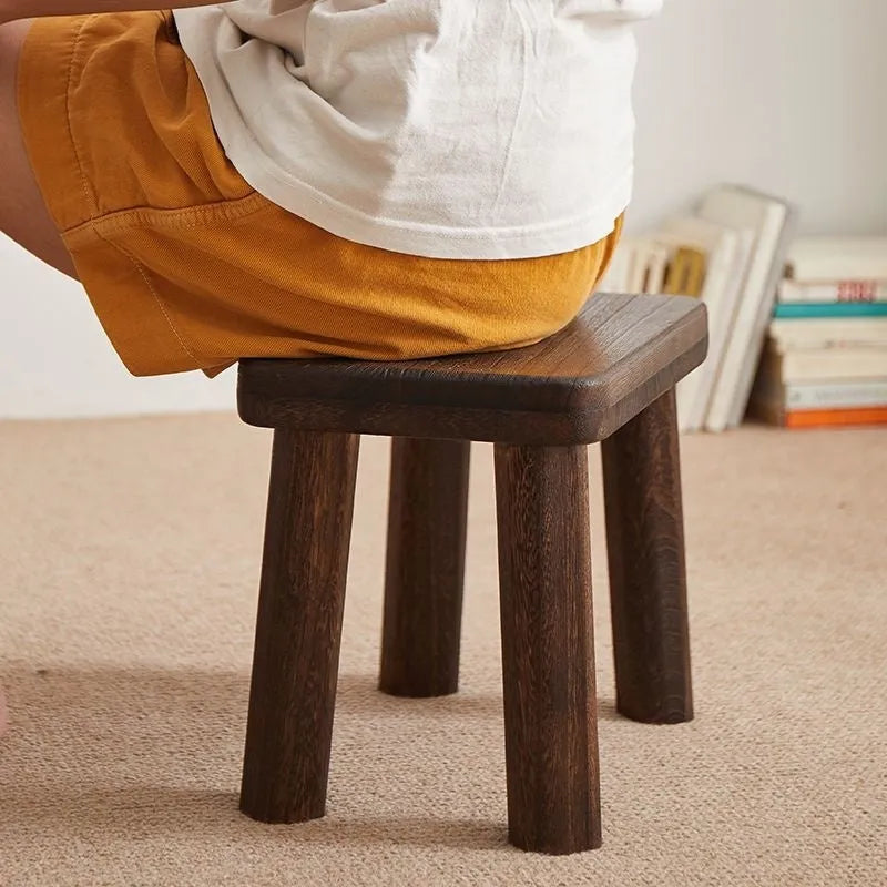 Solid wood household changing stool with a distressed finish and bracket structure.