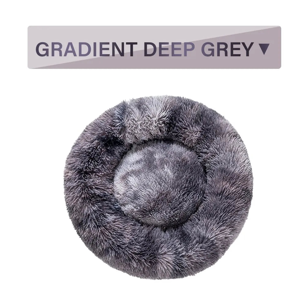 Fluffy donut-shaped pet bed in long plush material, showing raised edge and central well.