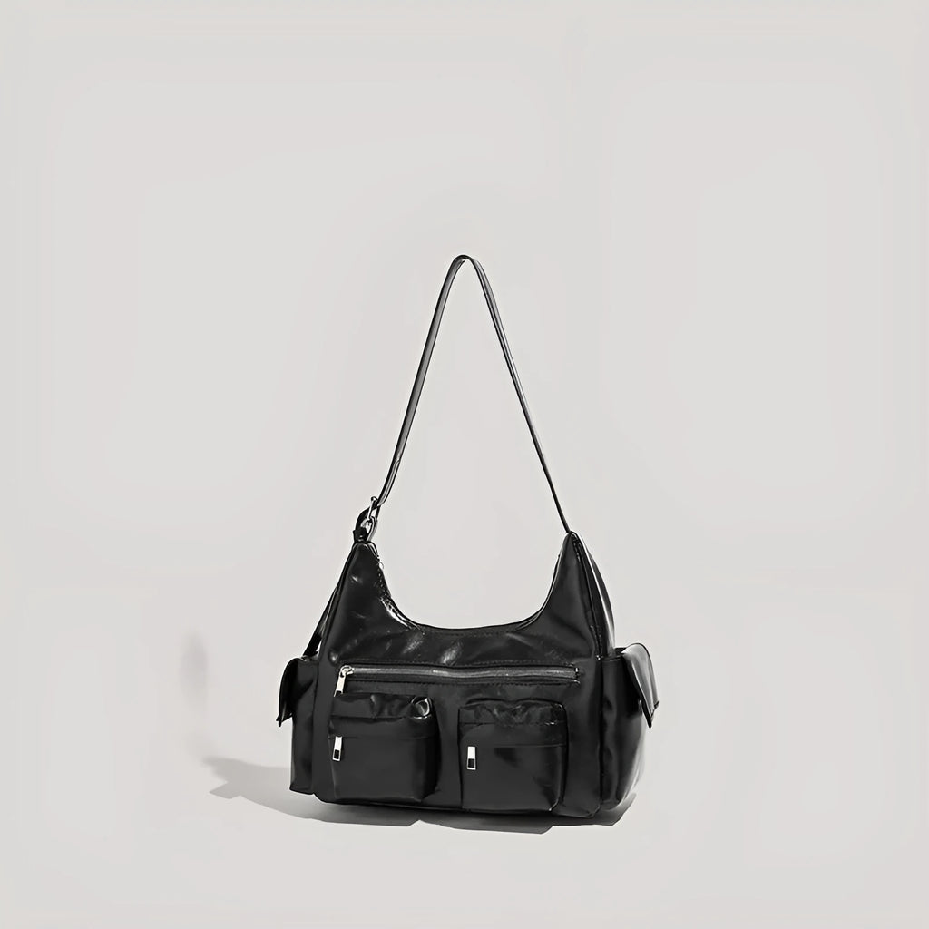 Black PU leather shoulder motorcycle bag with sewing line details against a plain background