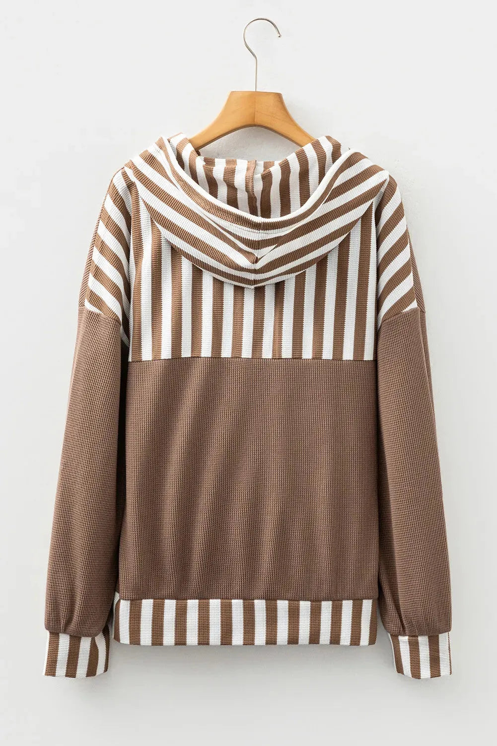 Straw yellow hoodie with striped patchwork design, waffle texture, button neck, and drawstring hood.