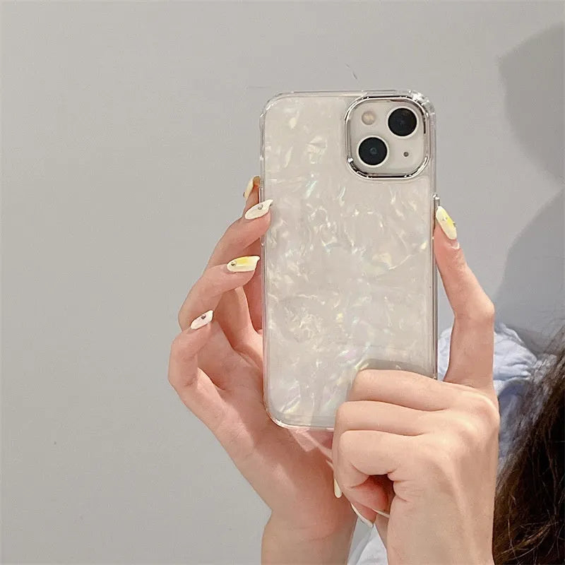 White TPU phone case with fantasy shell pattern compatible with iPhone 13 showing back design and side buttons