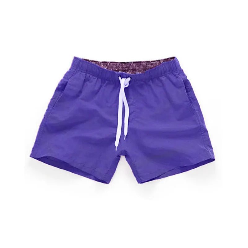 Men's black polyester beach shorts with a straight leg, shown on a size chart with options up to 4XL.