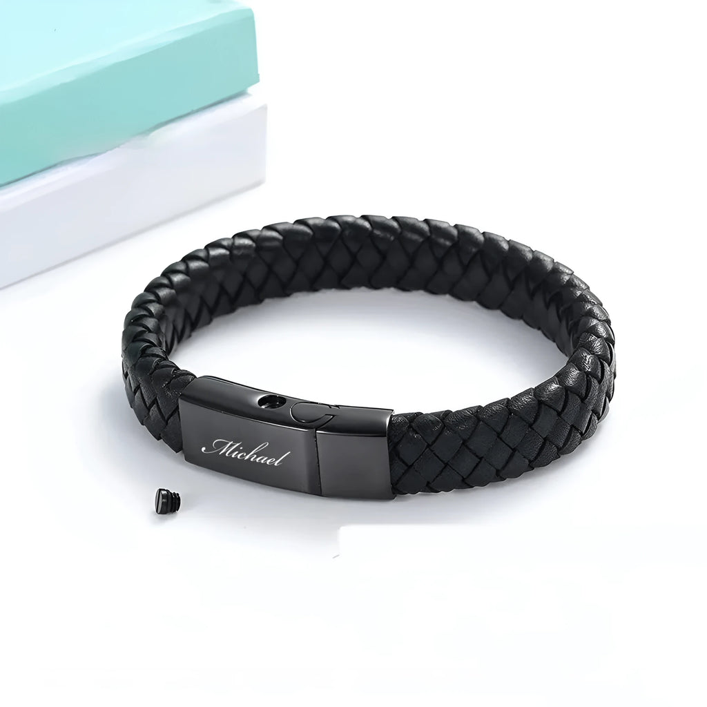Men's black leather and stainless steel casket bracelet with engraving option on a gift box.