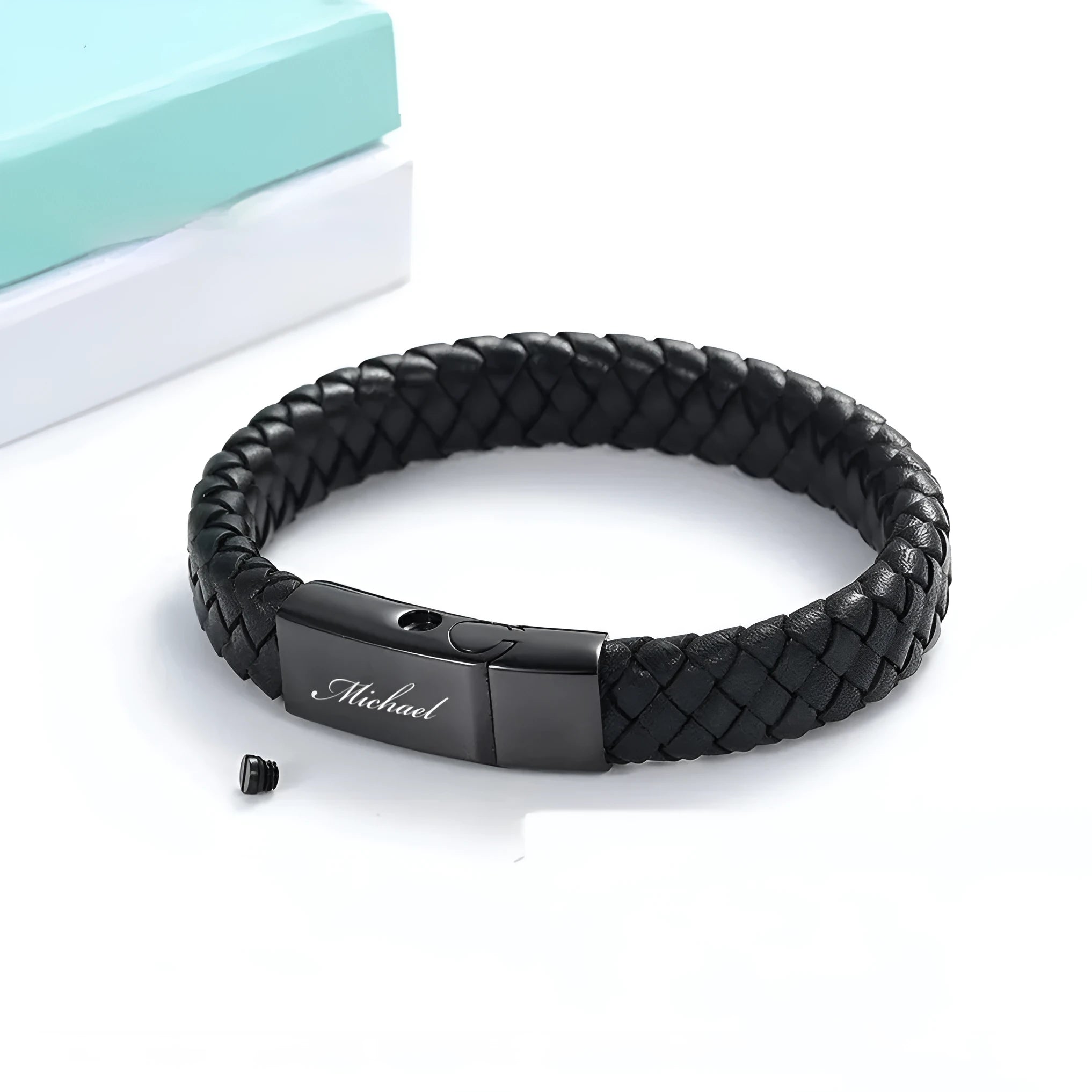 Men's black leather and stainless steel casket bracelet with engraving option on a gift box.