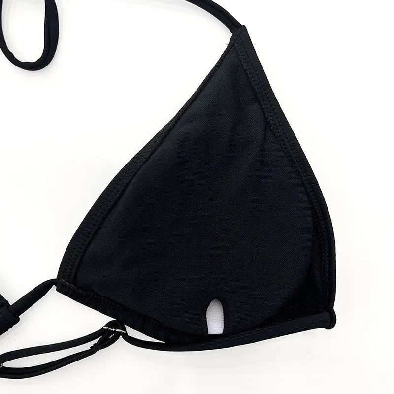 Black long sleeve mesh top and briefs from a women's four-piece bikini swimwear set.