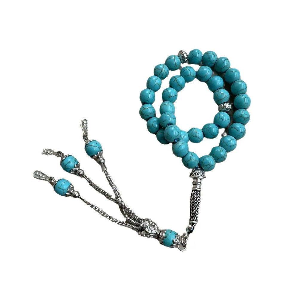Sky blue stone bead Muslim prayer bracelet with sliding knot on a wrist.