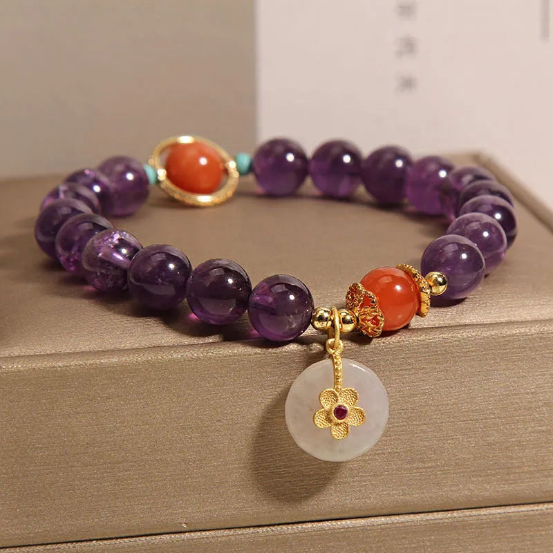 Natural amethyst bracelet with sliding knot and small flower inlay on a white background