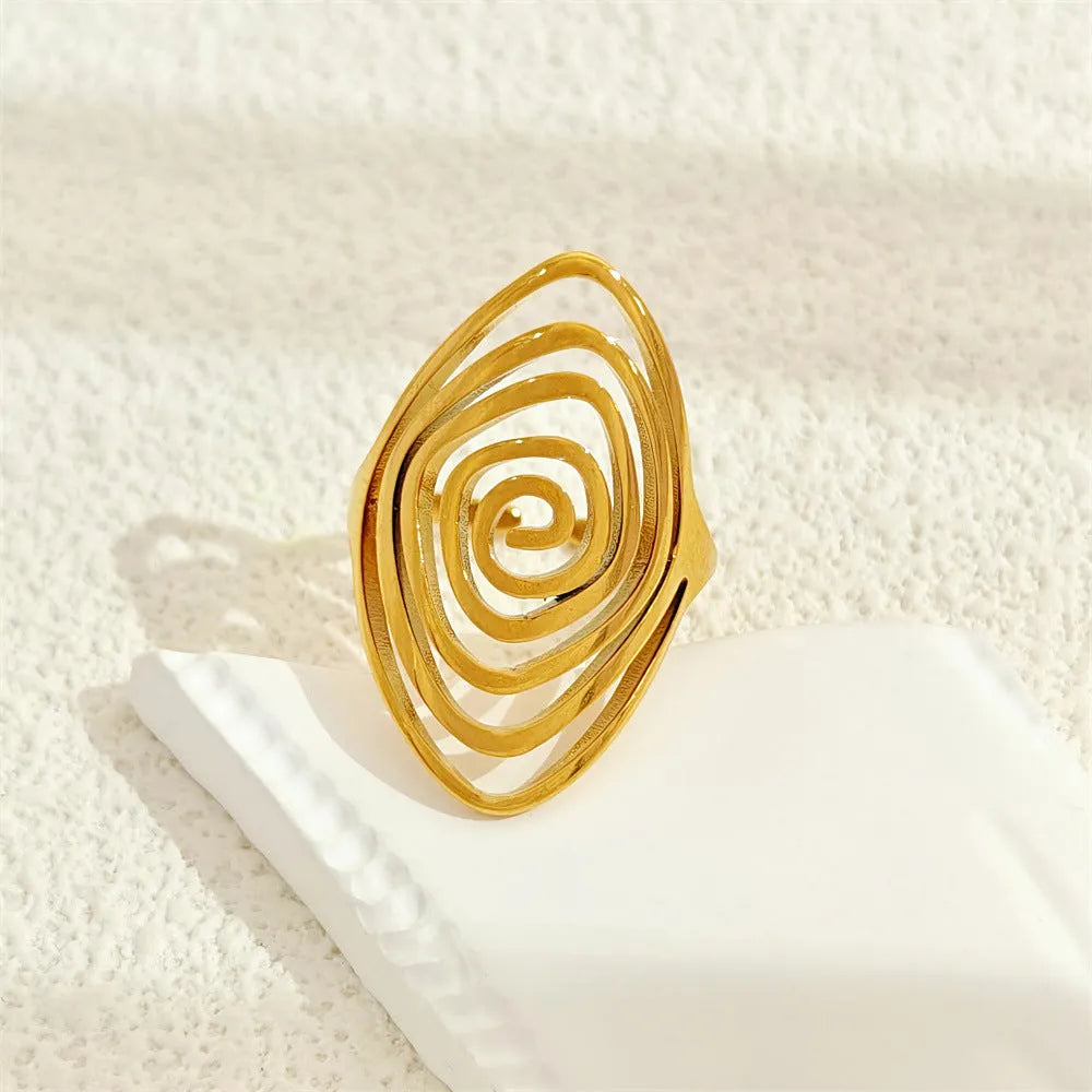 Stainless steel exaggerated circle geometric ring in gold colour, adjustable opening, front view.