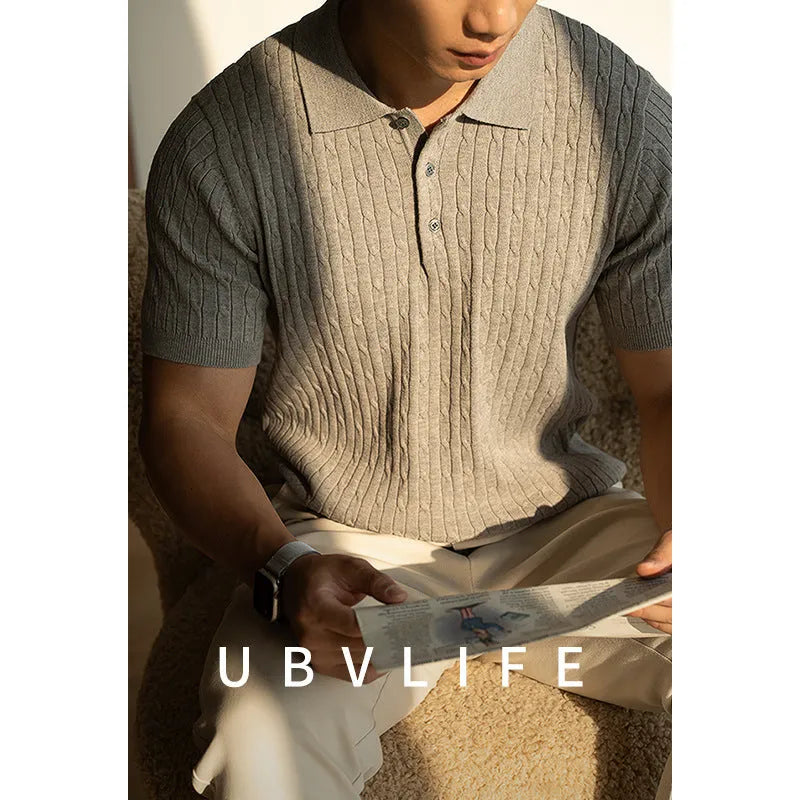 Men's khaki short-sleeve business top on a hanger, showing button placket and tailored fit.