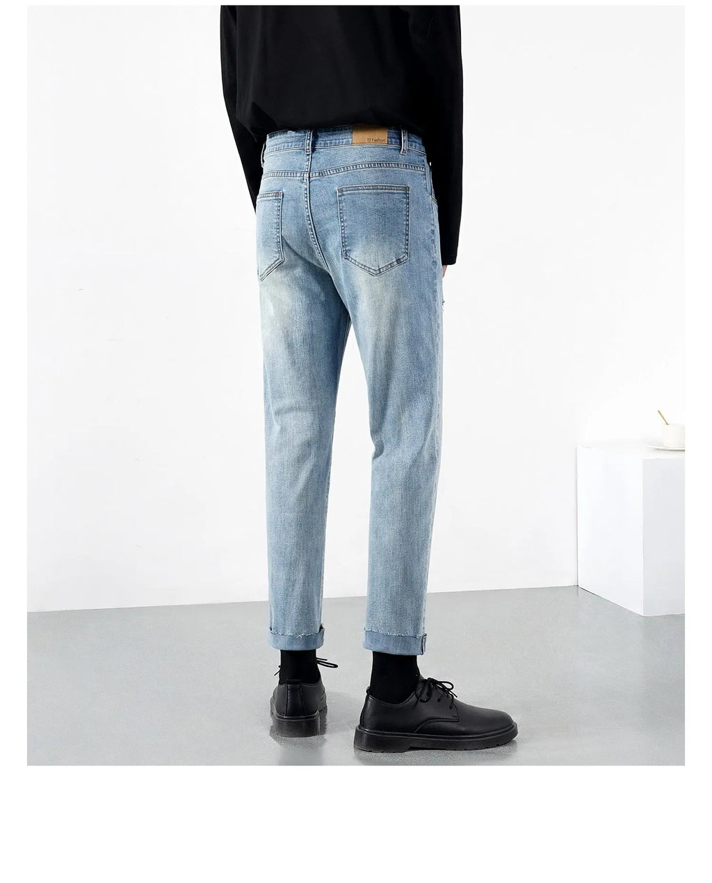 Men's light blue ripped jeans with microelastic cotton blend fabric, shown flat for size reference