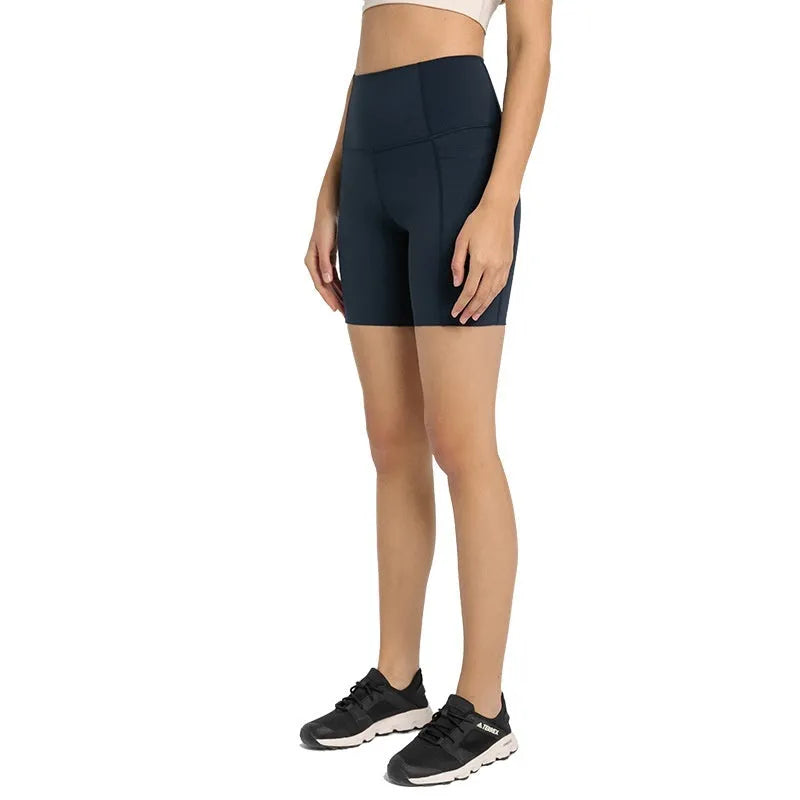 Women's solid colour sports shorts in a cotton blend fabric with super stretch, shown in a mid-length fit.