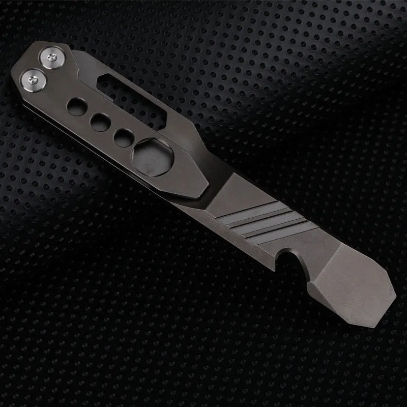 Titanium alloy multi-function crowbar tool with integrated bottle opener in gun grey or stone wash finish.