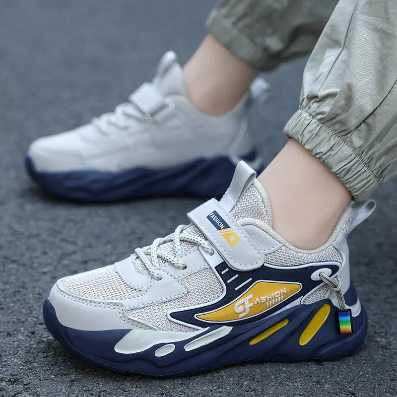 Boys dark blue and beige sports running shoes with Velcro strap and mesh upper.