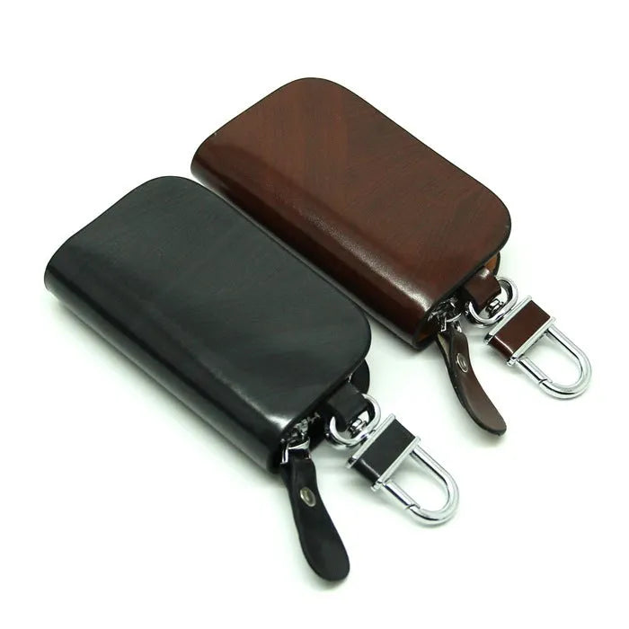 Black genuine leather car key case with a silver V-shaped zipper closed.