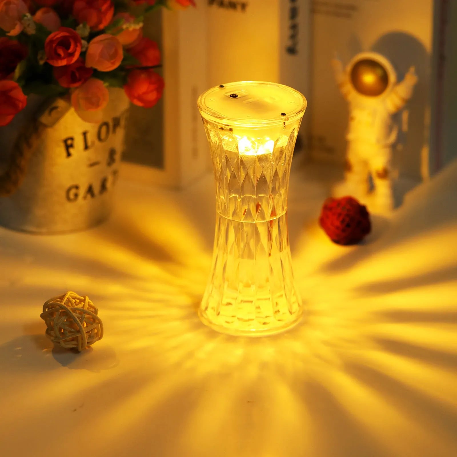 Clear acrylic crystal rose petal table lamp with plastic LED, warm white light, compact 12.2cm size on a desk