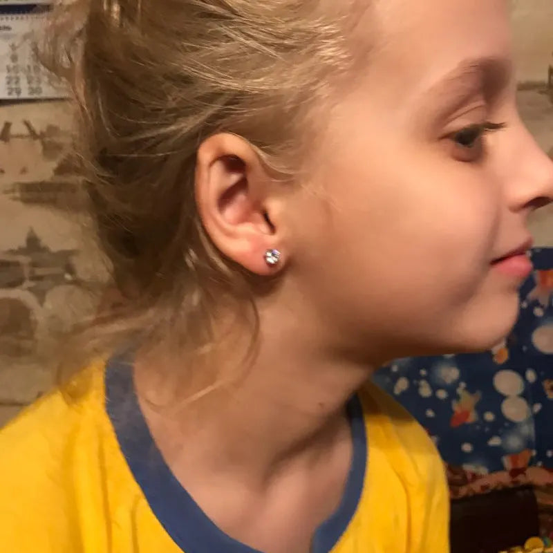 Disposable ear piercing gun with built-in crown stud in 316L stainless steel with zirconium inlay