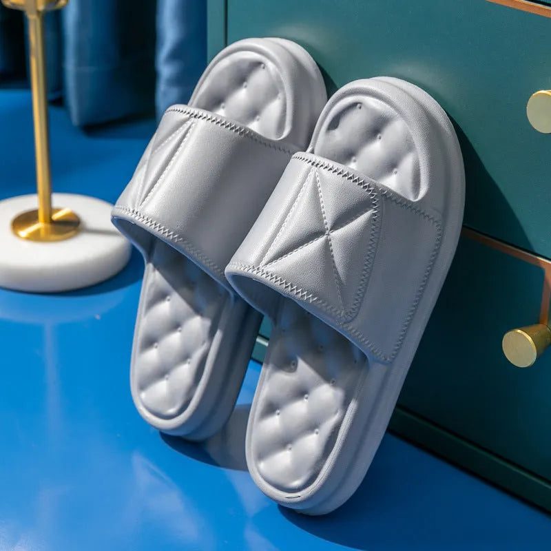 Unisex thick sole EVA bathroom slippers in black, shown on a wet tile floor.