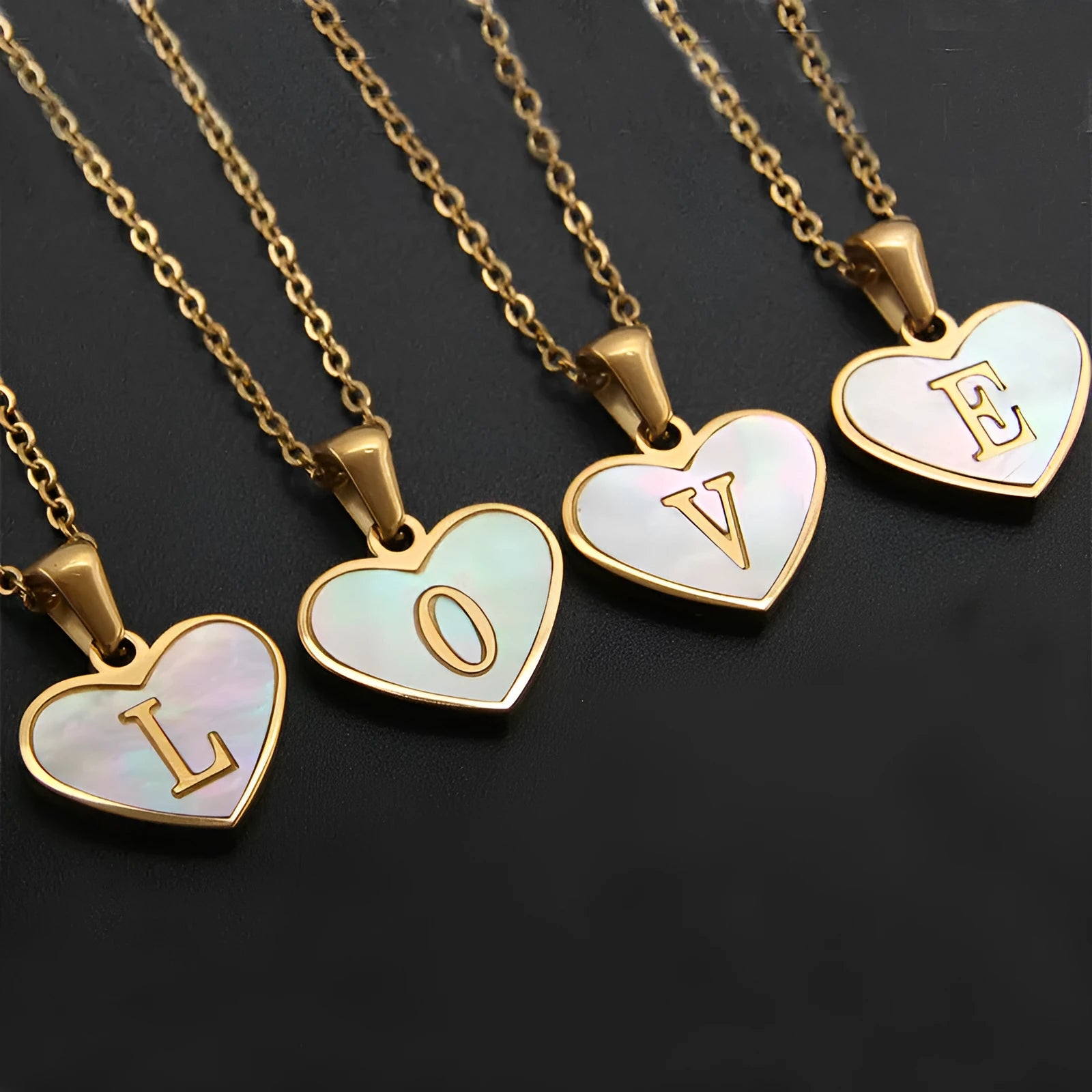Gold plated heart-shaped necklace with a personalised initial letter and white shell detail on a 50cm adjustable chain.