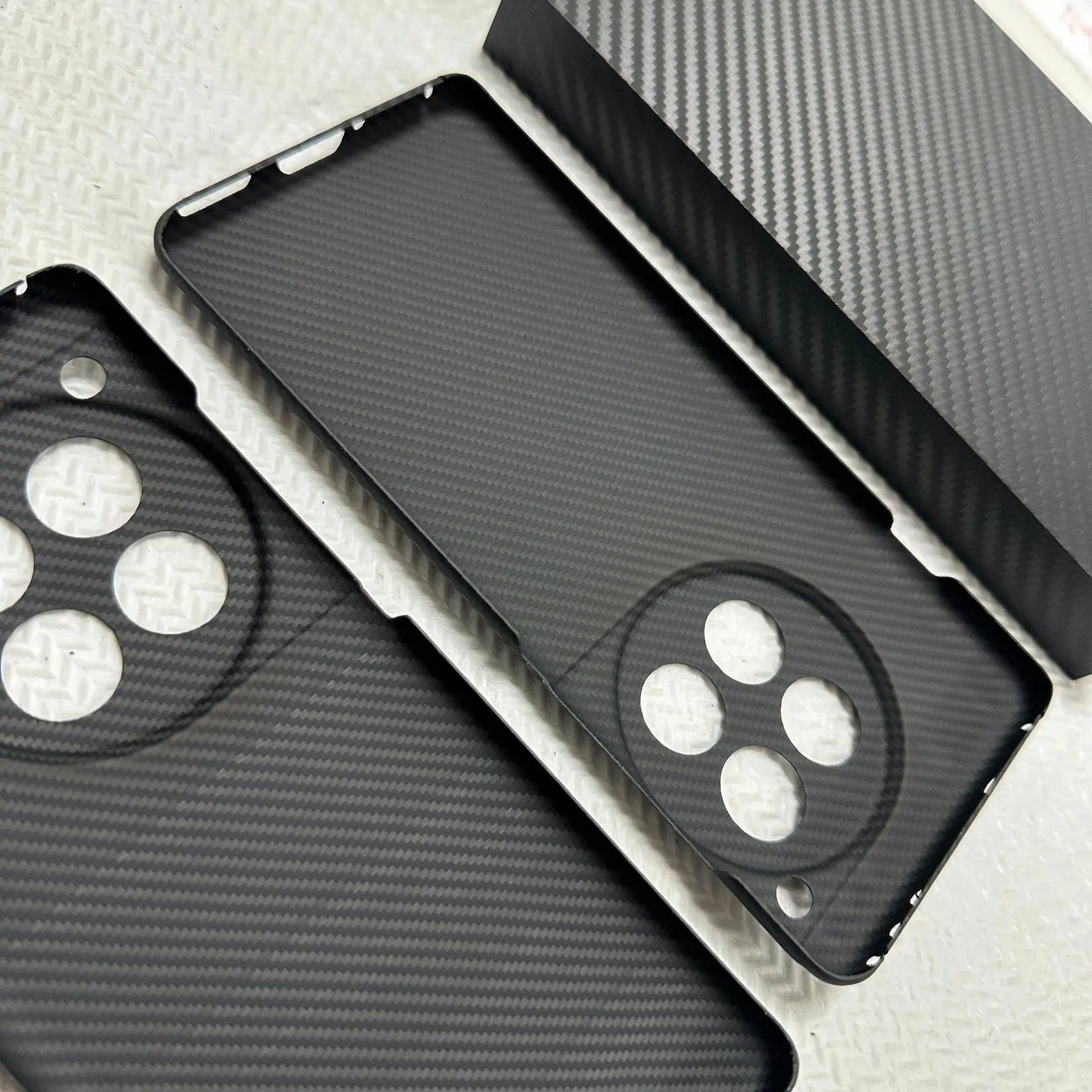 Black hand-woven Kevlar anti-wear phone case for OnePlus 12 with crater texture