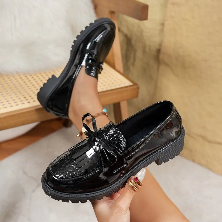 Women's black and brown casual loafers with a decorative bow on the artificial PU upper.