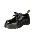 Women's thick-soled black shoes with cross strap and ribbon detail, lace-up closure