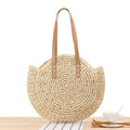 Round straw shoulder bag in large beige colour with zipper closure and woven texture