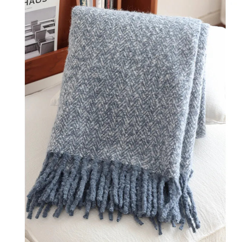 Navy blue polyester fibre leisure blanket folded on a simple sofa