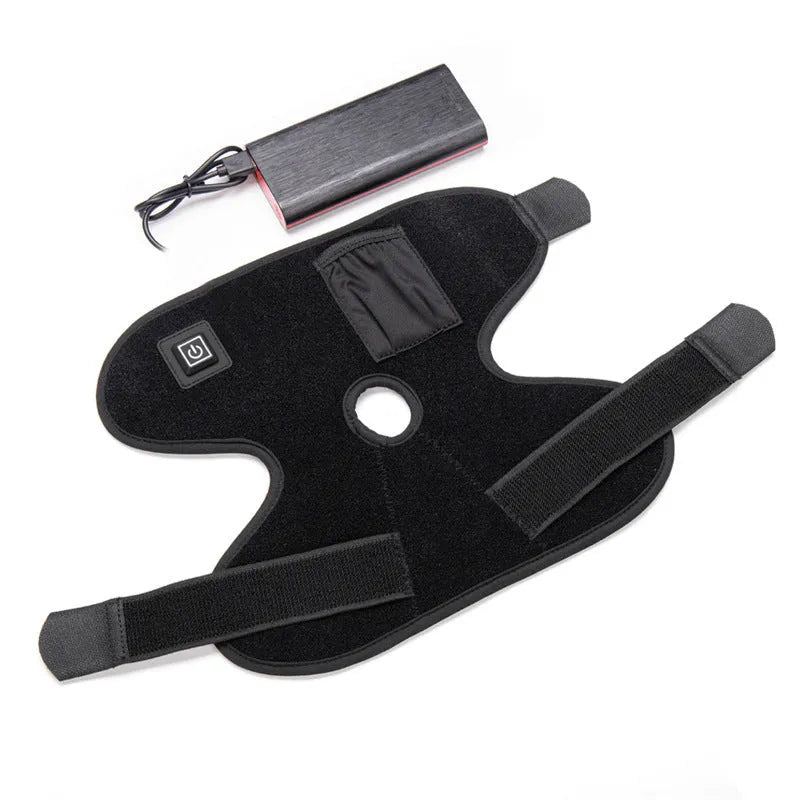 Black ankle heating wrap with red light therapy and USB cable on flat surface
