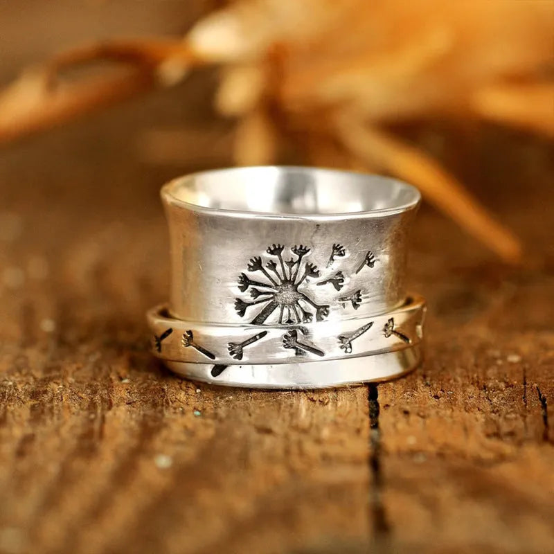 Silver-colour rotating flower ring showing floral element that moves independently of band