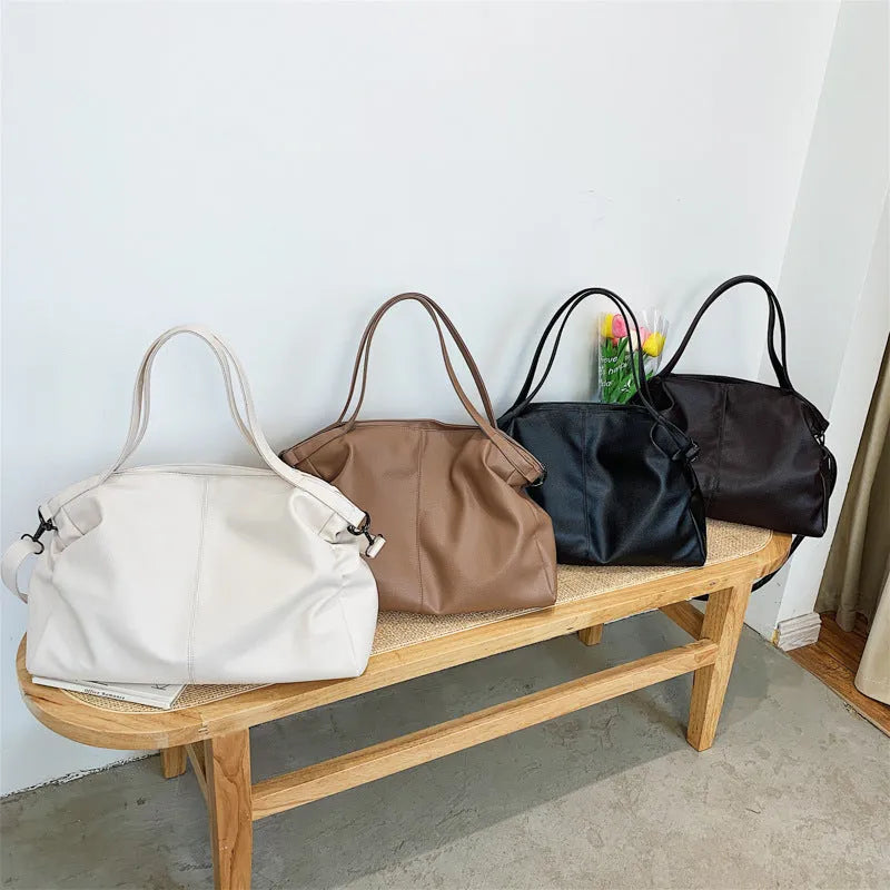 Large PU leather messenger bag with adjustable shoulder strap showing interior phone pocket organisation