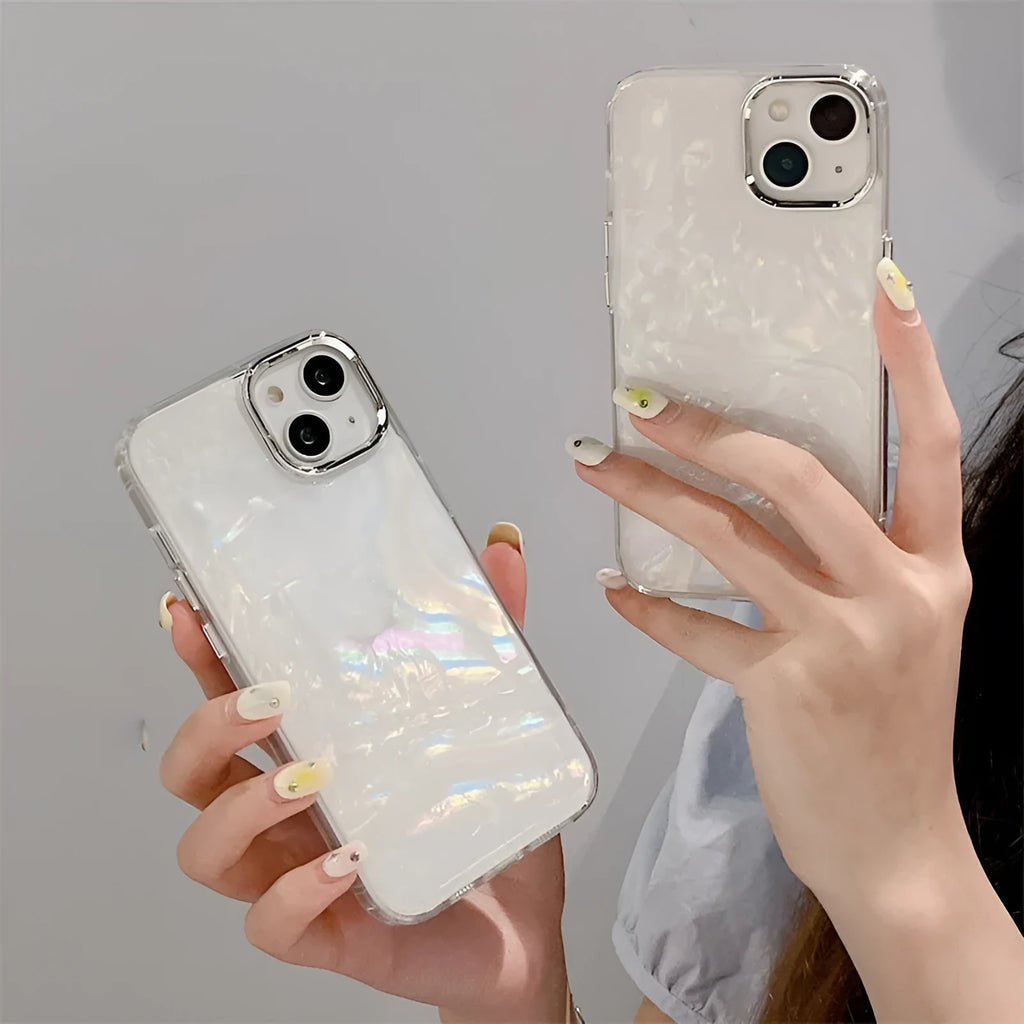 White TPU phone case with fantasy shell pattern compatible with iPhone 13 showing back design and side buttons