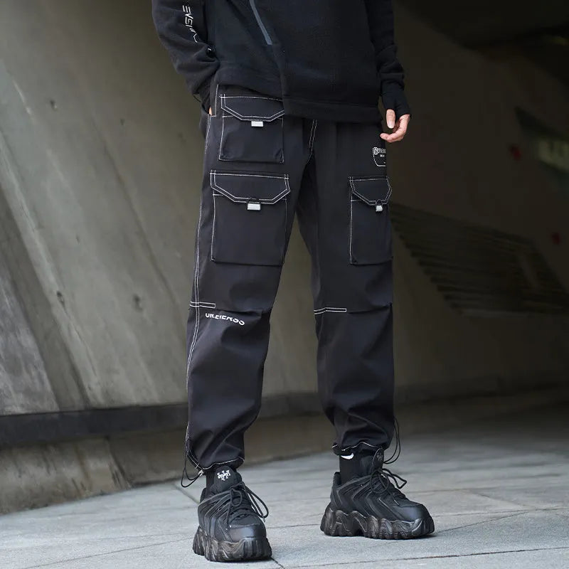 Men's black polyester overalls with bundled feet and cropped leg