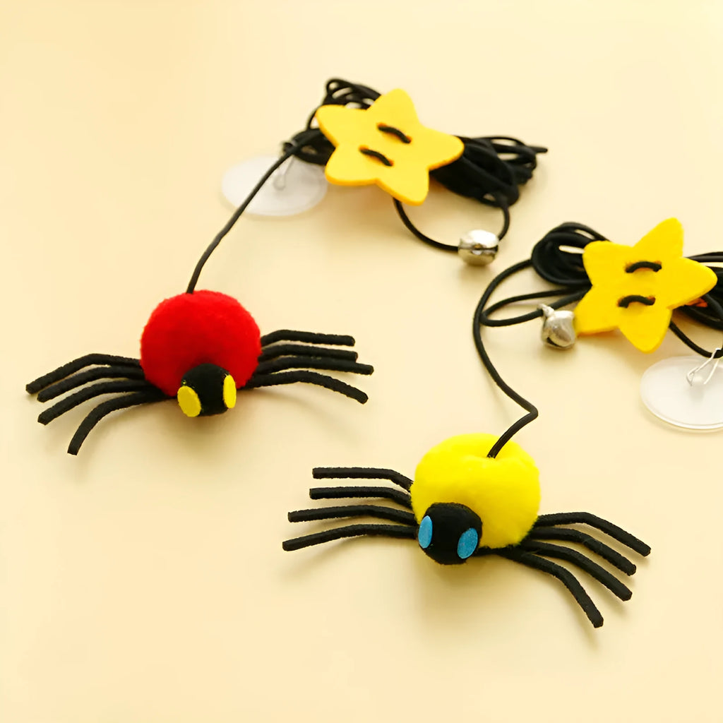 Cat hanging door toy with elastic rope featuring feather, bell and spider attachments in red or yellow colours